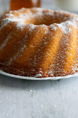 Homemade cake with powdered sugar and honey. On wood aphids. dessert.