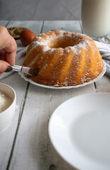 Homemade cake with powdered sugar and honey. On wood aphids. dessert.
