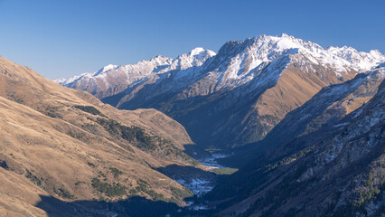 View of the buildings of the ski resort from above. View from the top of the mountain to the gorge with rest houses. Vacation at a ski resort. Vacation in the mountains.