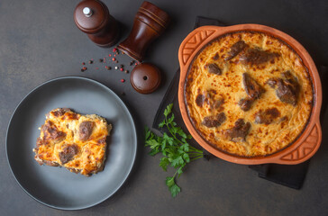 Tave kosi is a national Albanian dish of baked lamb and rice with yoghurt close-up in a pan on the table. horizontal top view from above. Turkish name; Elbasan tava