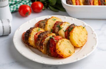 Traditional Turkish food; baked potatoes and meatballs. Turkish name; kofteli patates dizmesi, patates dizme