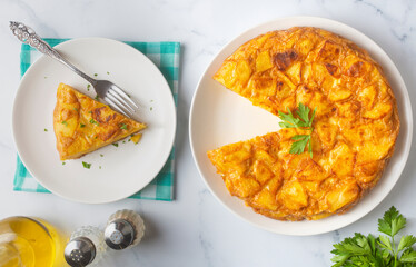 Spanish omelette with potatoes, typical spanish cuisine on gray concrete floor. Tortilla Espanola. Turkish name; Yumurtali patates