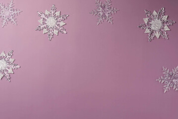 Snowflakes on a purple background and space for text