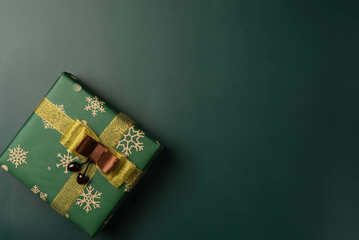 Top view of green Christmas box on green background