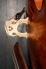 Detail of Contrabass. Wooden musical string instrument. Wooden Double bass bridge and strings. Close up. Shallow depth of field © VLAD ANTONOV
