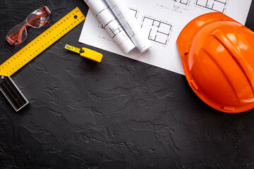Construction drawing blueprints with helmet, top view. house designing and architect plan concept