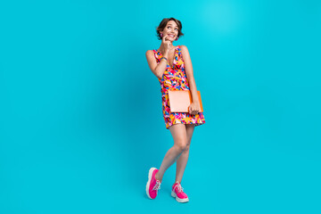 Full length photo of tricky cunning girl dressed print outfit holding modern gadget looking empty...