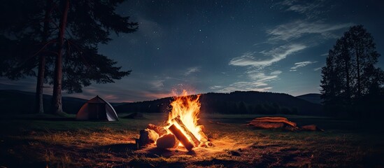 Summer night campfire replaced by camp base under the stars