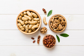 Walnut kernel halves, in a wooden bowl. Close-up, from above on colored background. Healthy eating Walnut concept. Super foods with copy space