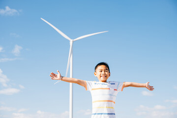 A happy boy in a wind farm's environment. Family joy and carefree moments near turbines celebrating...