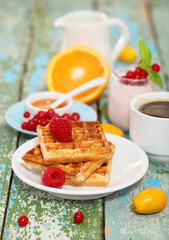 Delicious breakfast with fresh coffee, fresh waffles and fruits