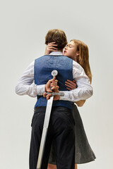 Modern portrait of young couple in codependent hypertrophied toxic relationship. Woman hugs man...