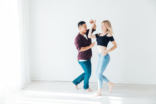 Couple dancers man and woman dancing in studio workout