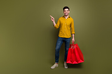 Full length photo of glad nice man recommend buy autumn collection outfit empty space isolated on...