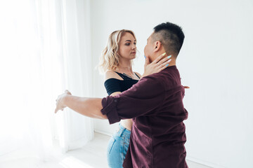Man and woman dancing in studio couple dancers workout