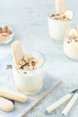 Milk mousse dessert with nuts in glasses	
