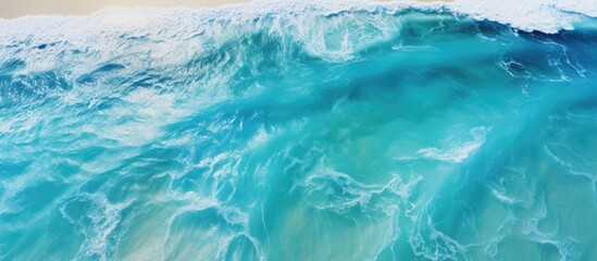 Beautiful aerial view of tropical turquoise ocean waters with shallow waves on a vibrant sunny summer day