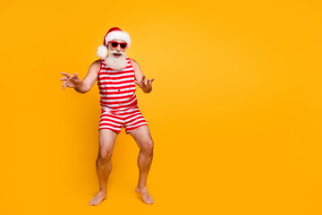 Full length photo of funky excited senior guy dressed christmas swimwear dancing discotheque empty...