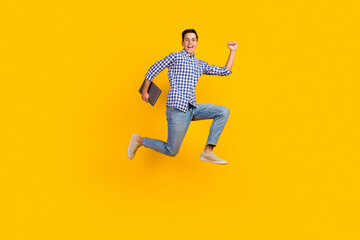 Photo of guy wear shirt jumping high typing modern device isolated vivid color background