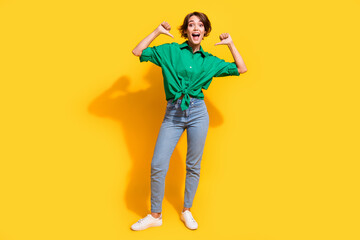 Fototapeta premium Full length photo of impressed funky lady wear green shirt showing thumbs herself isolated yellow color background