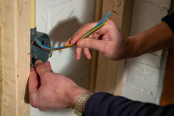 Constructing and installing electrical wiring with the brown phase, the blue neutral and the yellow...
