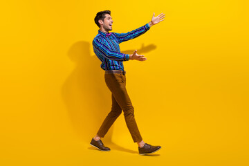Fototapeta na wymiar Full body photo of overjoyed man wear vintage bow tie stylish shirt stretching arms to empty space isolated on yellow color background