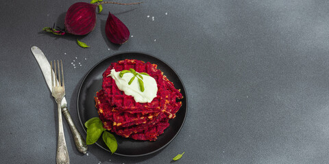 Homemade beetroot Belgian waffles with sauce. Gluten free vegan food with vegetables