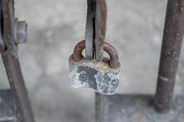 old lock on a rusty grille