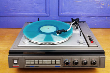 Obraz premium Vintage turntable vinyl record player with turquoise vinyl