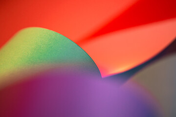 Colorful abstract paper texture background. Curled sheets of paper. Oval waves shape. Macro...
