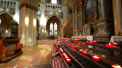 Fribourg, Switzerland Circa March 2022 - Interior of Saint Nicholas Cathedral with candles lit for...