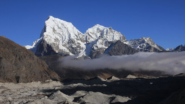 Ngozumba Glacier and high mountains Cholatse and Tobuche, Nepal.