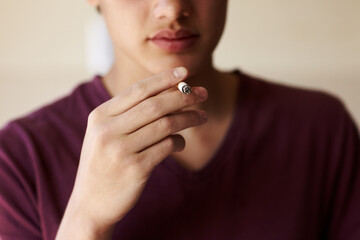 Man, hand and cigarette closeup for smoking teen or unhealthy habit, dangerous or addiction. Male...