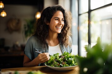 A young woman leads a healthy lifestyle and enjoys a fresh salad. - obrazy, fototapety, plakaty