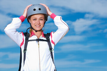 Skydiving, worry and portrait of woman on adventure with helmet and anxiety or stress on sky...