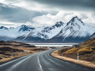 a narrow roadway going towards mountains covered with snow in in winters