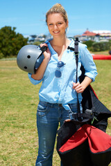 Skydiving, portrait and woman outdoor for adventure with gear and helmet in countryside with a...