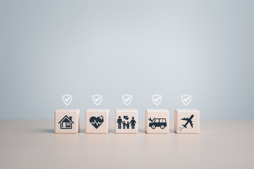 Life, House, Car, Family, Business, Travel, and Health insurance concepts. Wooden cube with...