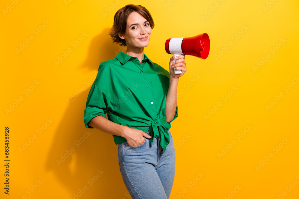 Sticker Photo of funky good mood girl dressed green shirt rising toa empty space isolated yellow color background