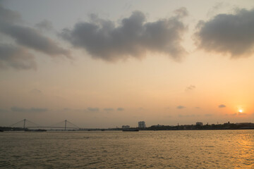 Vidyasagar Setu bridge with fishing boat on river Ganges at sunset at Kolkata India