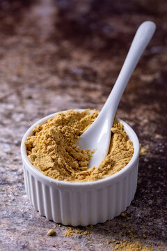 Ginger powder placed in a ceramic bowl, macro