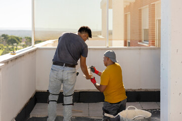 team workers measuring tiles to place on the floor