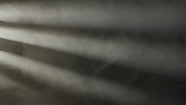 Rays of light from a spotlight through window sashes illuminate thick, dense smoke or fog on a black background close up. Abstract background of smoke and fog. HDR BT2020 HLG Material.