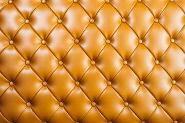 Leather couch in vintage style. Brown - ocher color. Pattern background with buttons.