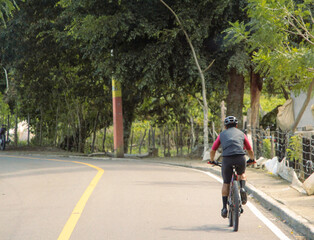 Cyclist riding bicycle on the road, Dominican Republic