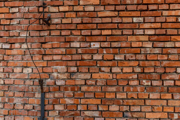 Fototapeta premium Old red brick wall damaged lightning rod collapsing brick wall