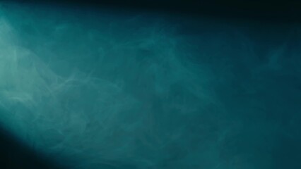 Abstract background of chaotically blending puffs of blue smoke on a black background. Realistic...