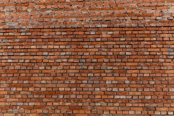 Red brick building scheduled for demolition, wrongly placed wall by the bricklayer