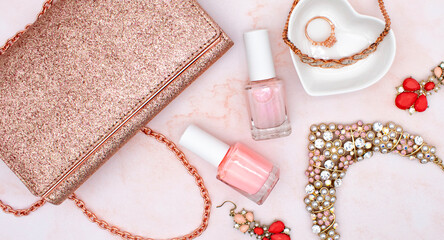 Rose gold flat lay fashion and jewelry concept with rose quartz background, pink nail polish,...