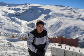 young latin guy with cold,playing in the snow,ski resort sierra nevada,granada,granada,spain